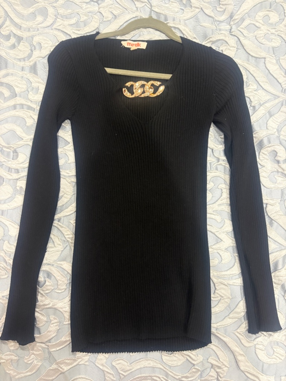 Black Ribbed V‑Neck Sweater with Gold Accent
